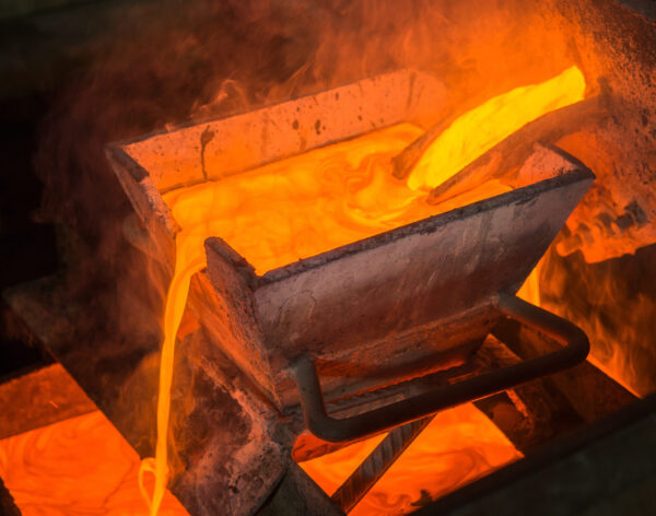 Casting gold at a factory. Gold mining.